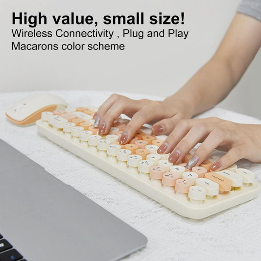 Wireless keyboard in cream with matching mouse next to a laptop